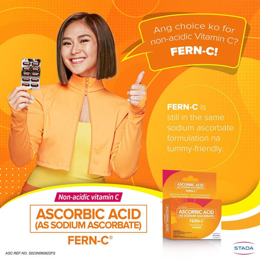 Person holding a package of FERN-C non-acidic Vitamin C supplement with promotional text on an orange background.