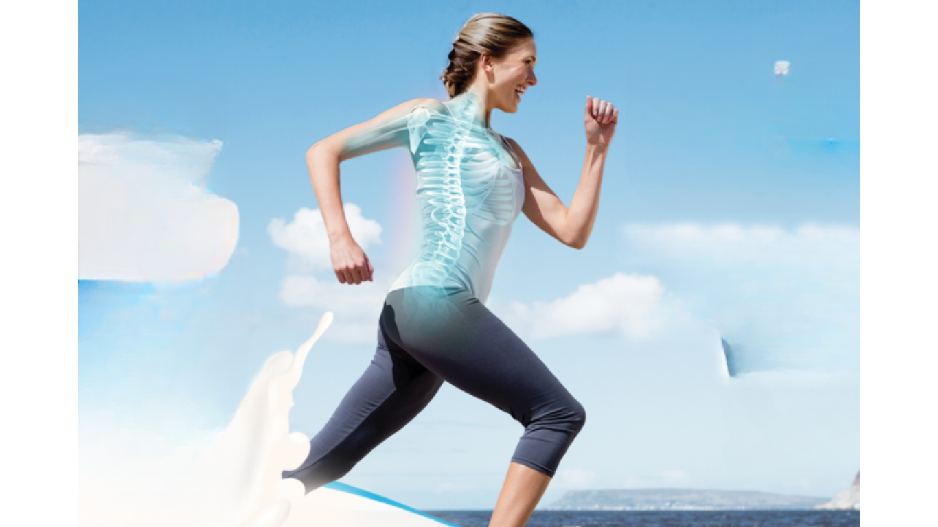 women on the beach running with highlighting her spinal cord 