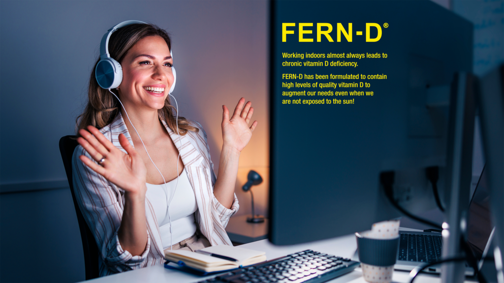 Woman wearing headphones and smiling at a desk with FERN-D branding on the side. Buy online at i-ferndistributorusallc.com 